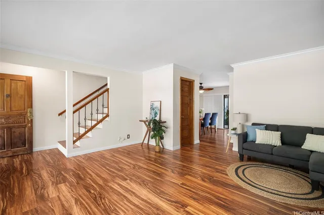 a living room with furniture and a dining table