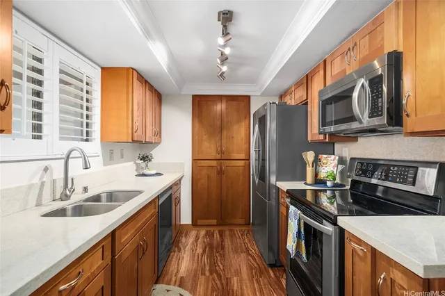 a kitchen with stainless steel appliances granite countertop a sink stove and refrigerator