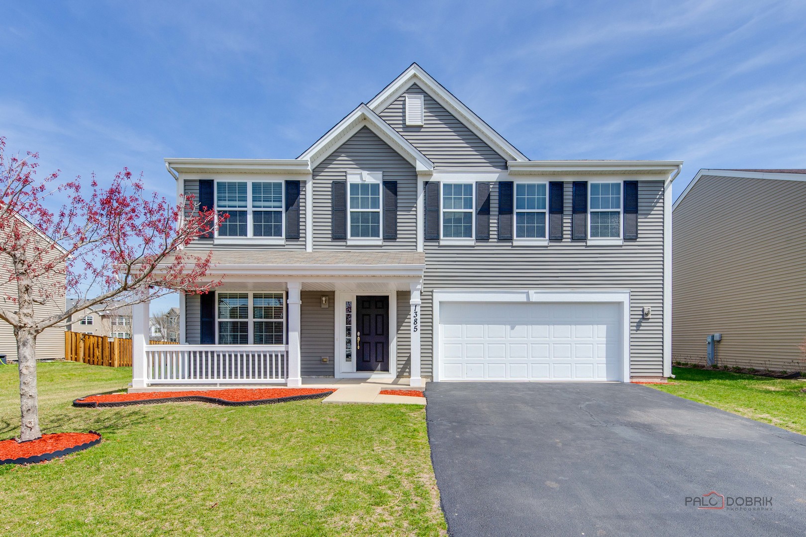 1385 Broadland Drive Pingree Grove, IL 60140 - Photo 1 of 40 a front view of a house with a yard and garage