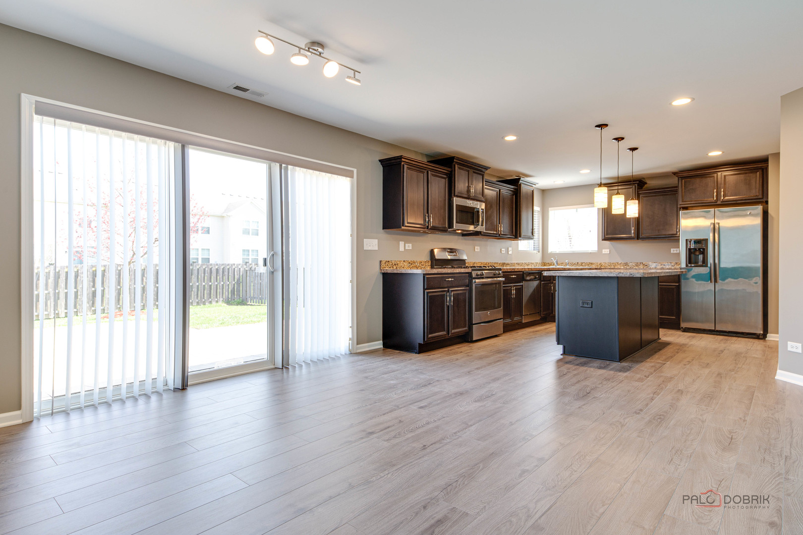 1385 Broadland Drive Pingree Grove, IL 60140 - Photo 13 of 40 a large kitchen with stainless steel appliances granite countertop a stove and cabinets