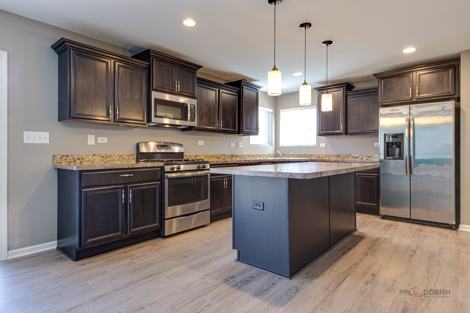 1385 Broadland Drive Pingree Grove, IL 60140 - Photo 16 of 40 a kitchen with stainless steel appliances granite countertop a stove a sink and a refrigerator