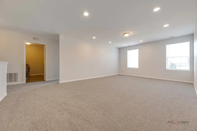 an empty room with windows and closet