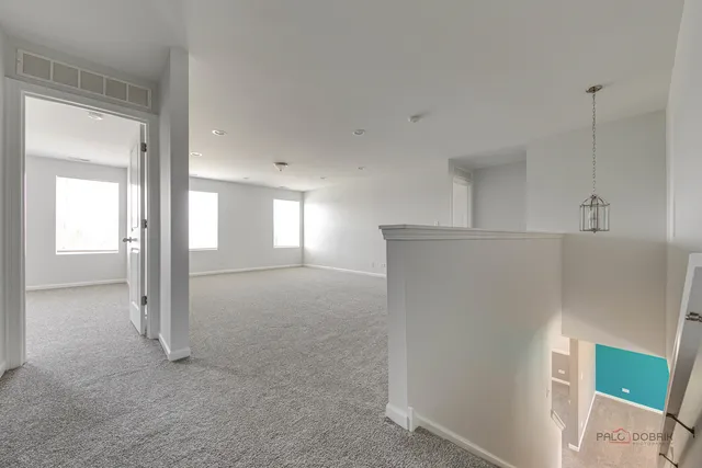 a view of a big room with closet and windows