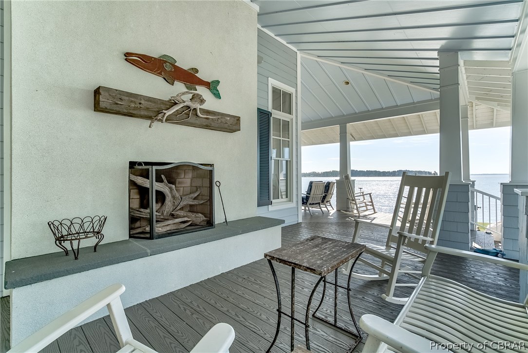 904 Queenstown Road Lancaster, VA 22503 - Photo 28 of 40 Outdoor Fireplace: 11 x 50 wrap around covered porch with 6? pvc flooring, vaulted ceilings and large wood burning outdoor fireplace overlooking the Corrotoman River and pool.