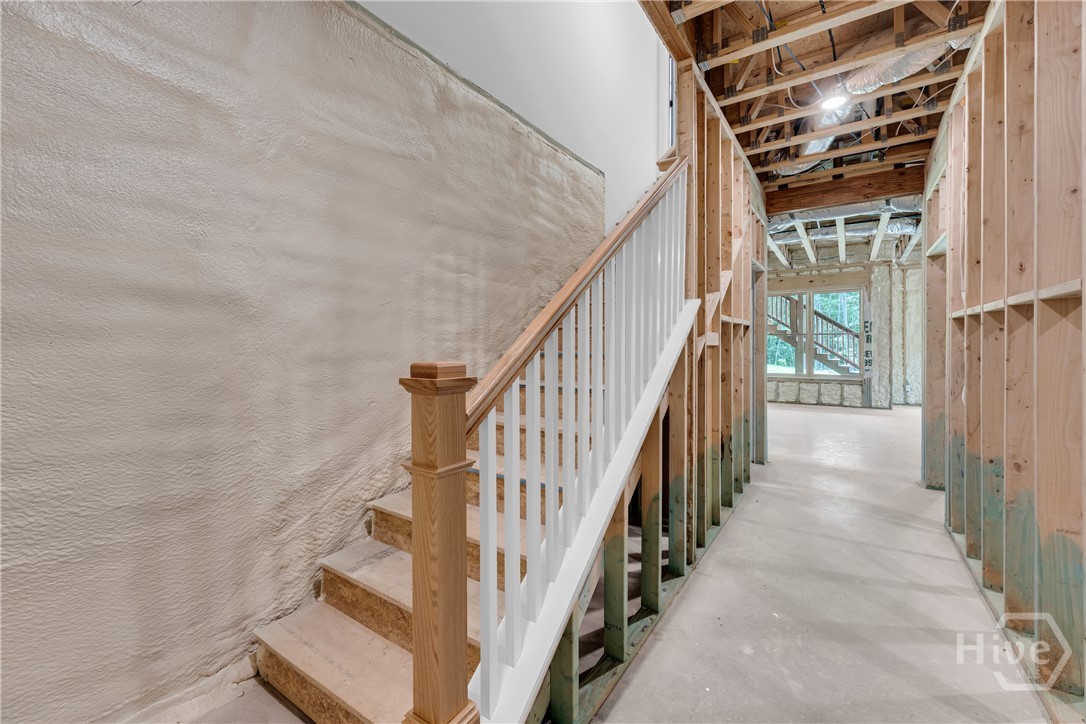 2476 St Martin Way Monroe, GA 30656 - Photo 68 of 75 Unfinished lower level featuring a framed staircase with wood newel post and white balusters