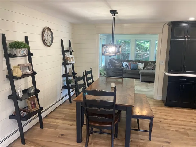 a view of a dining room with furniture wooden floor and a chandelier