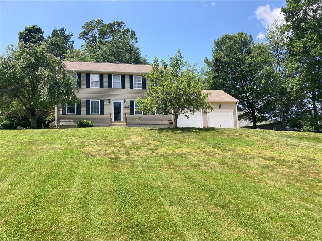 337 Mason Rd Extension Dudley, MA 01571 - Photo 2 of 31 a view of a house with a big yard and large trees
