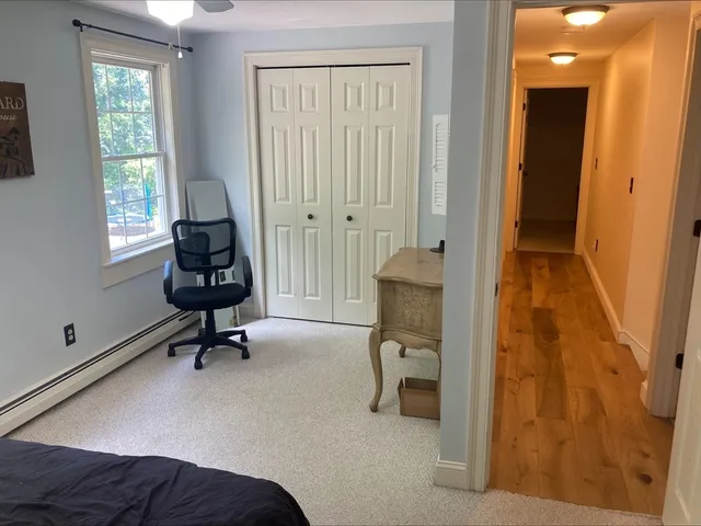 a view of a bedroom with a window and a bathroom