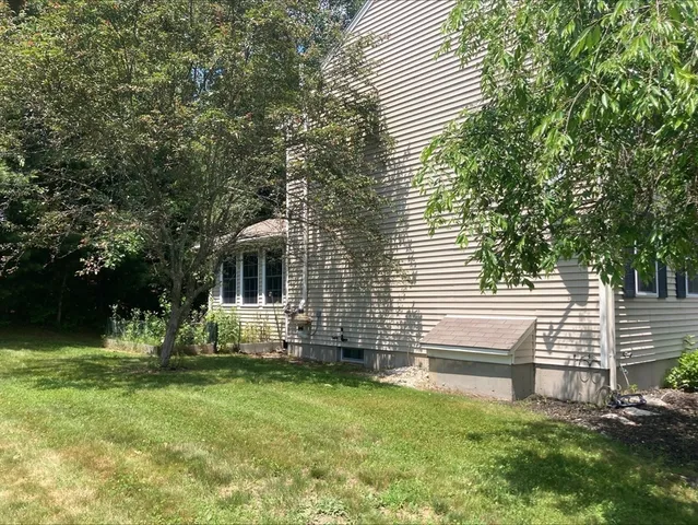 a view of a house with backyard and sitting area