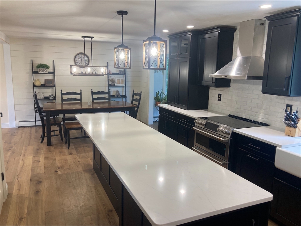 337 Mason Rd Extension Dudley, MA 01571 - Photo 6 of 31 a kitchen with stainless steel appliances granite countertop a sink a stove and a refrigerator