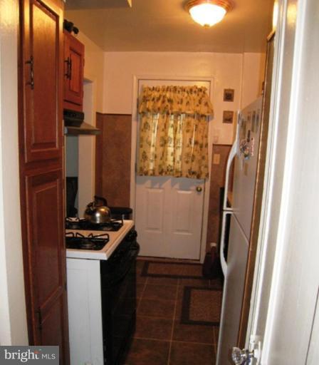 3601 28th Street Northeast Washington, DC 20018 - Photo 3 of 24 a bathroom with a sink a mirror a vanity and a shower