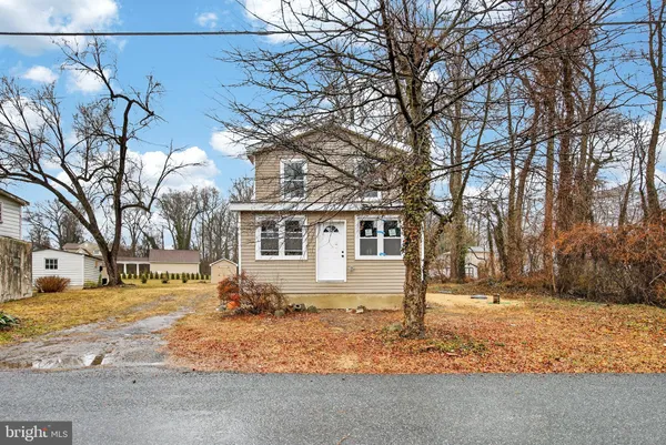 a view of a white house with a yard covered with snow