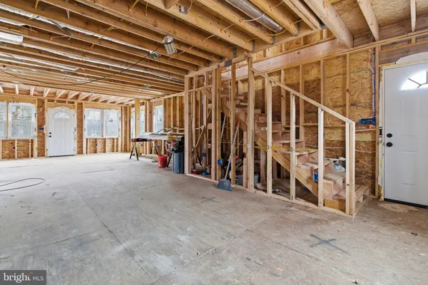 a view of porch with a door and wooden floors