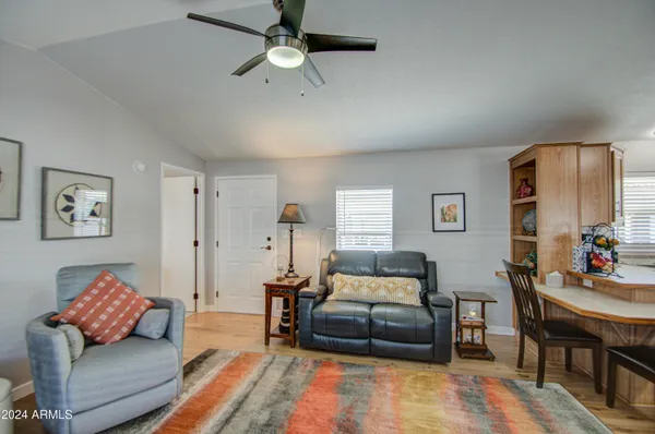 a bedroom with furniture and a wooden floor