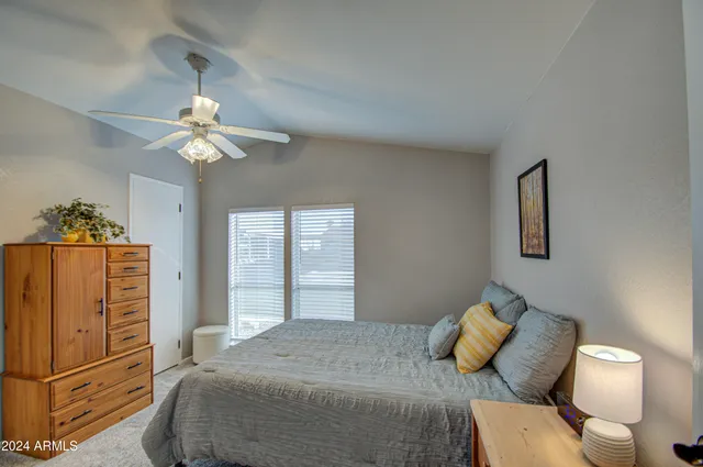 a bedroom with a bed and ceiling fan