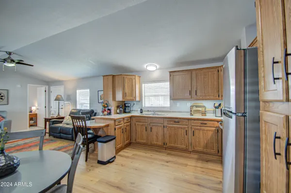 a kitchen with a sink refrigerator and cabinets