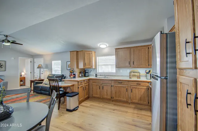 a kitchen with a sink refrigerator and cabinets