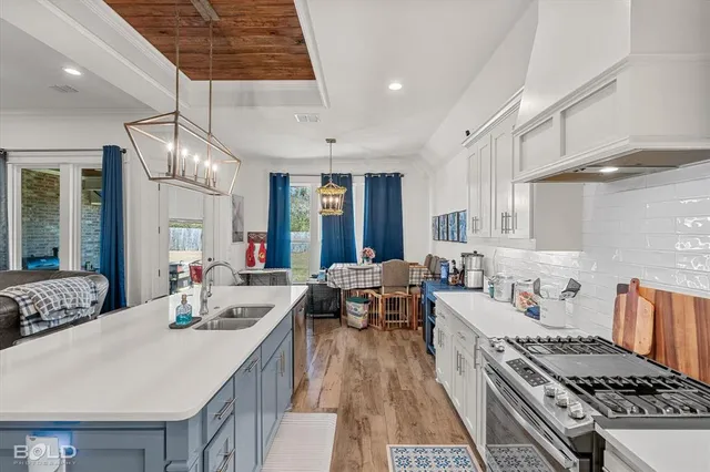 a large kitchen with sink stove and a refrigerator