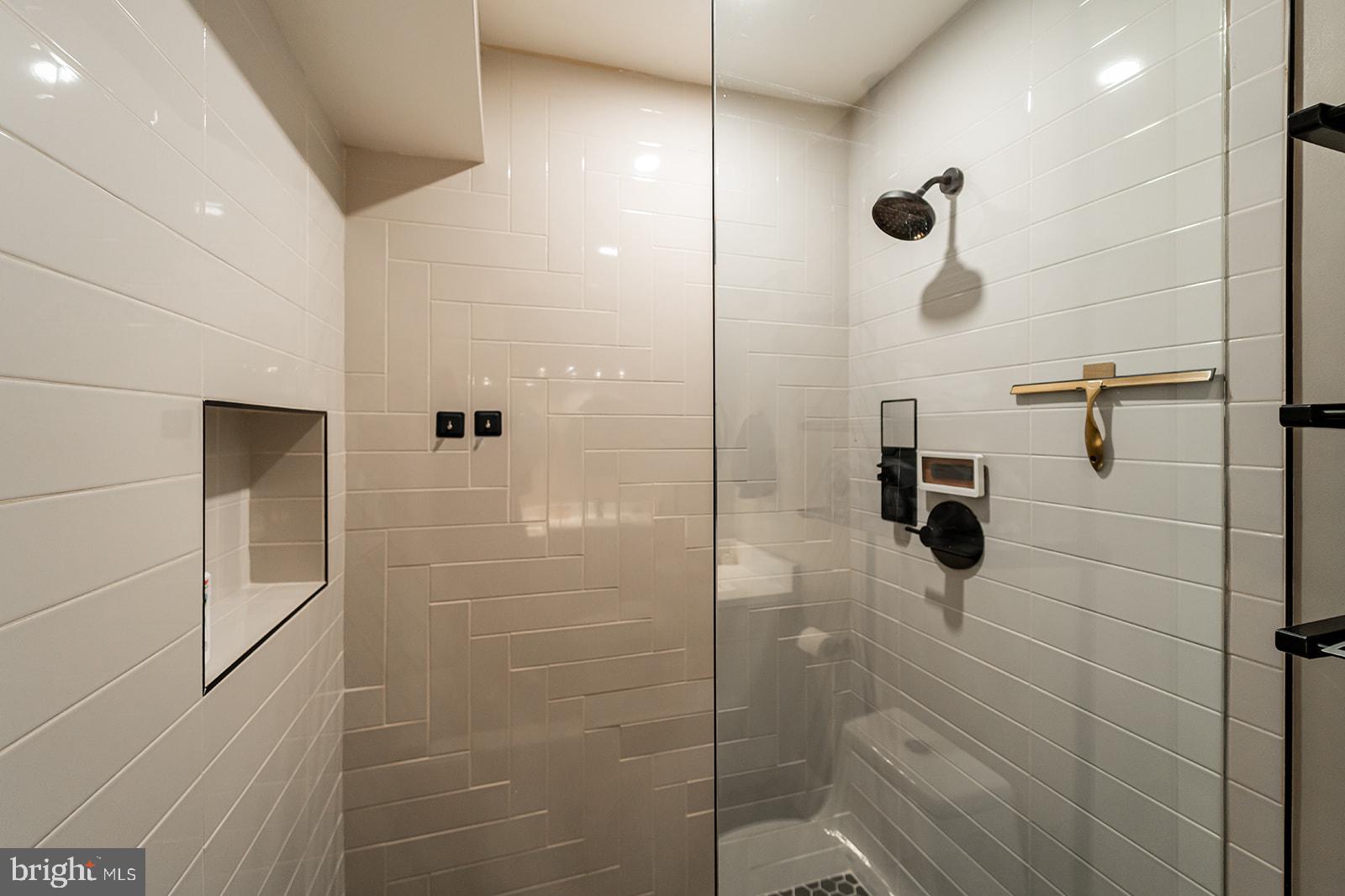 1919 Bennett Place Northeast Washington, DC 20002 - Photo 10 of 18 Sleek modern shower with elegant tiles.