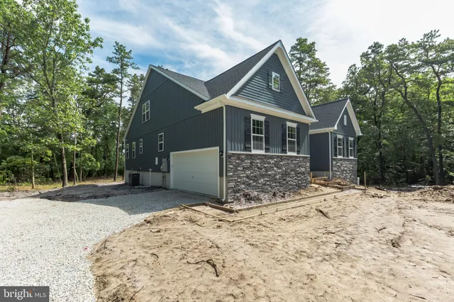 a view of a house with a yard covered in snow