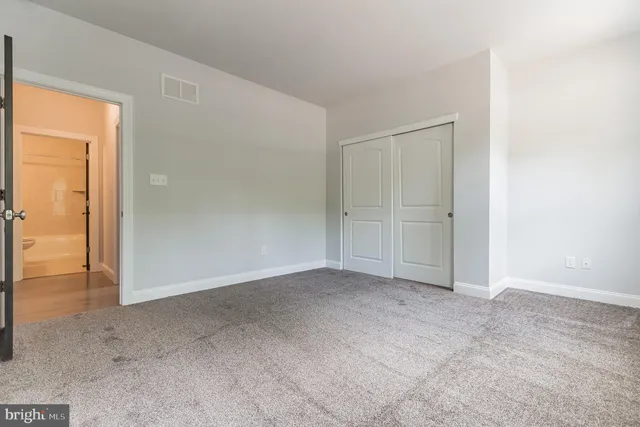 an empty room with closet area