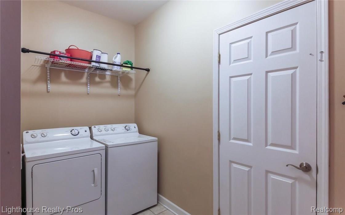 6180 Brophy Road Howell, MI 48855 - Photo 21 of 29 Laundry room off of garage and door leading to stairway into concrete "short basement"!