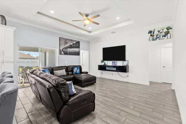 a living room with furniture and kitchen view