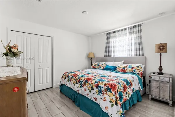 a bedroom with a bed and flat screen tv