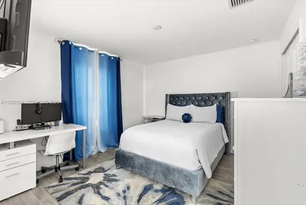 a bedroom with a bed and a flat screen tv