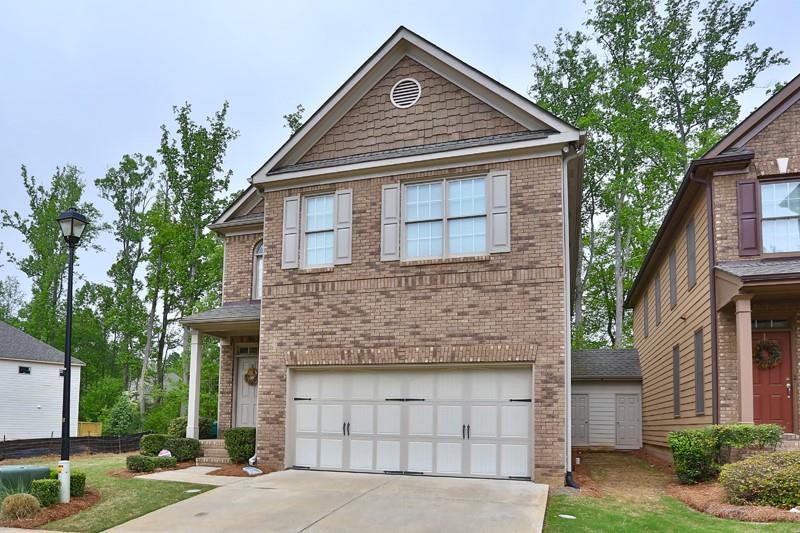300 Ridgemill View Milton, GA 30009 - Photo 1 of 1 a front view of a house with a yard and garage