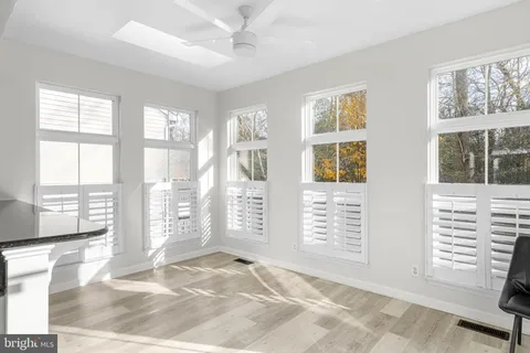 a view of kitchen and kitchen with granite countertop sink
