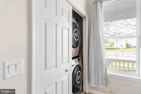 a bathroom with a toilet a sink and a window