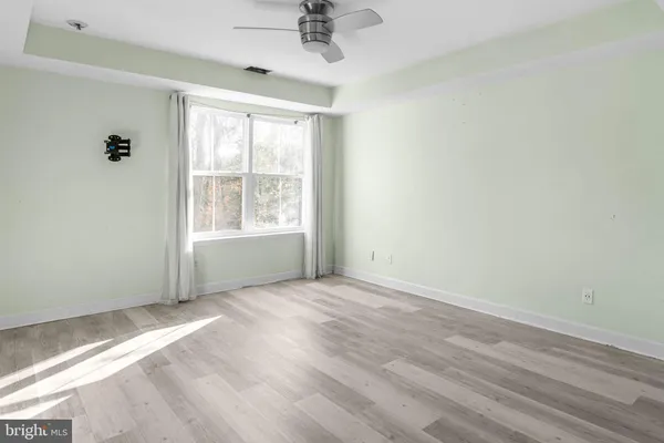 a view of a livingroom with a ceiling fan and entryway