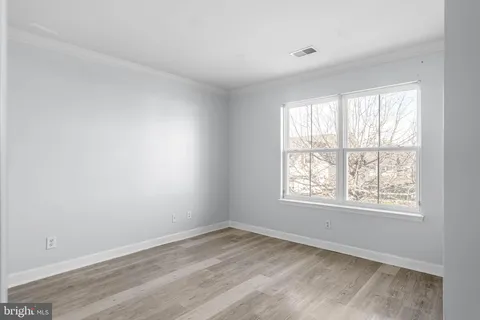 a view of room with wooden floor