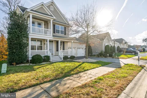 a view of swimming pool with lawn chairs and plants