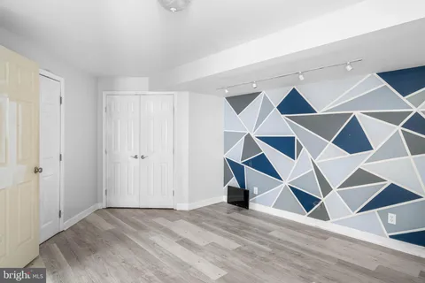 an empty room with a window and a chandelier