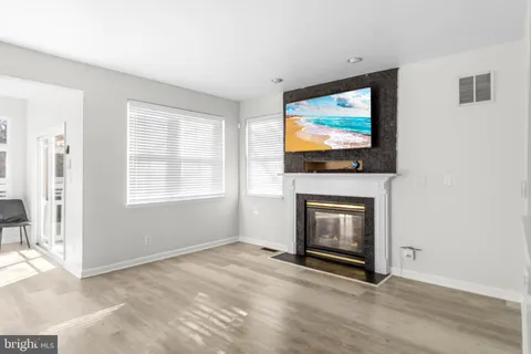 a living room with fireplace and flat screen tv