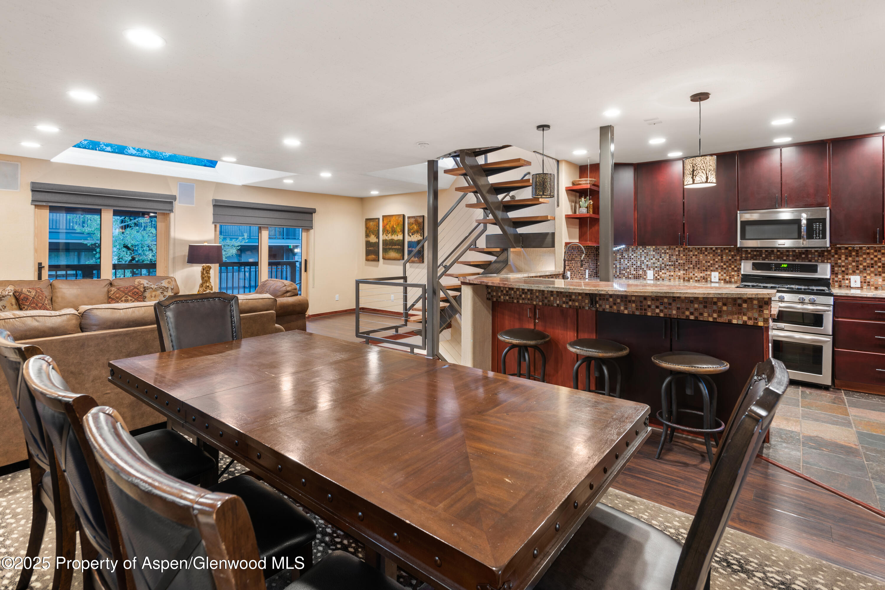 650 South Monarch Street, Unit 4 Aspen, CO 81611 - Photo 13 of 37 a large kitchen with stainless steel appliances a dining table and chairs