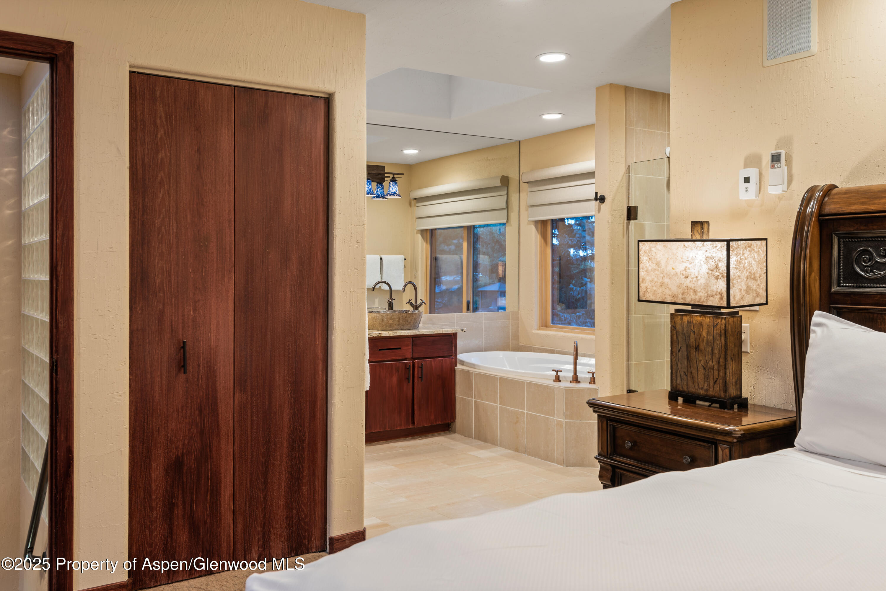 650 South Monarch Street, Unit 4 Aspen, CO 81611 - Photo 17 of 37 a bedroom with a large bed and a glass door