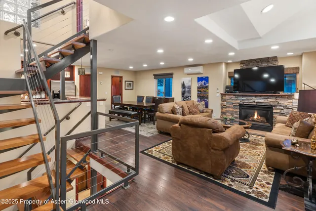 a living room with fireplace furniture and a flat screen tv