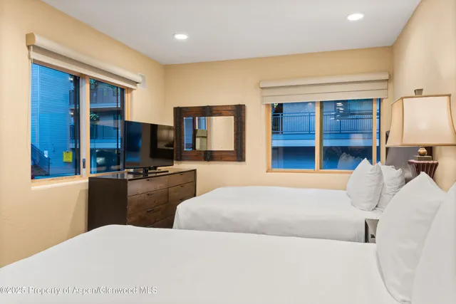 a bedroom with a bed and a television