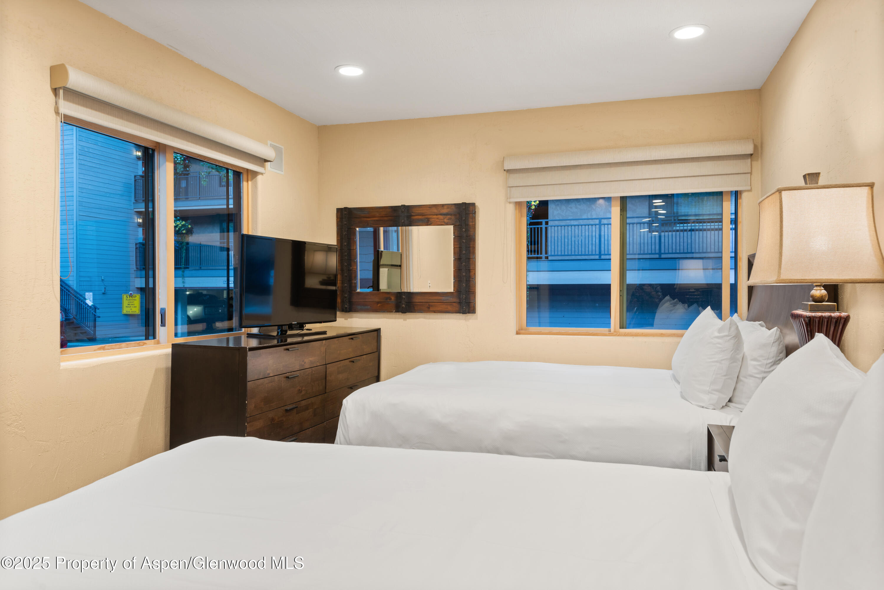 650 South Monarch Street, Unit 4 Aspen, CO 81611 - Photo 26 of 37 a bedroom with a bed and a television