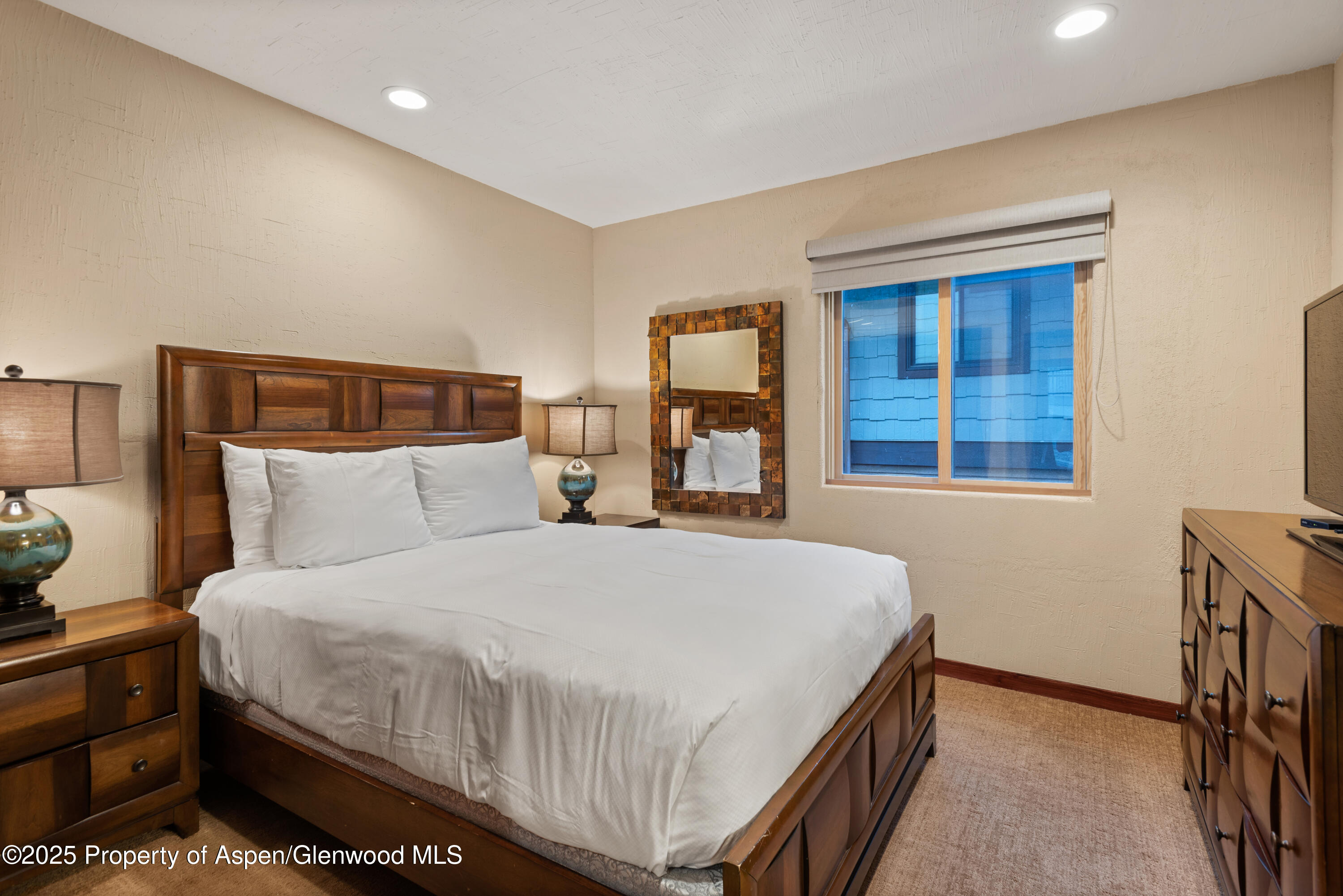 650 South Monarch Street, Unit 4 Aspen, CO 81611 - Photo 28 of 37 a bed sitting in a bedroom next to a window