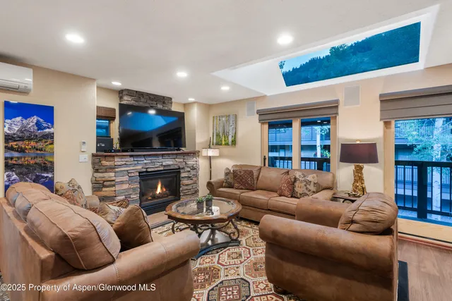 a living room with fireplace furniture and a flat screen tv