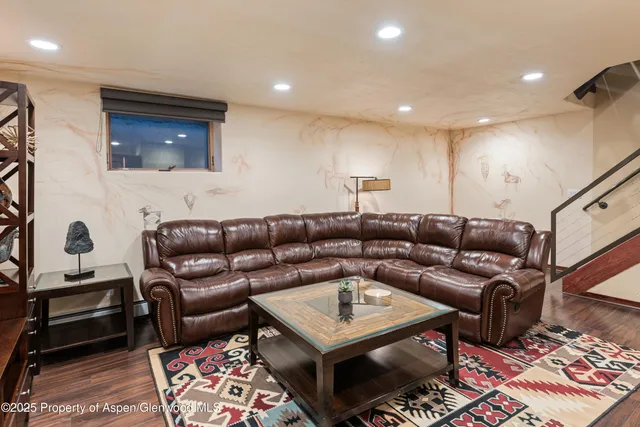 a living room with furniture and a rug