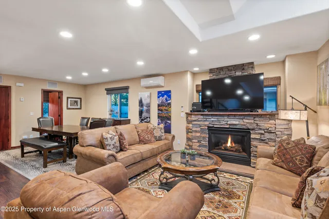 a living room with furniture a fireplace and a flat screen tv
