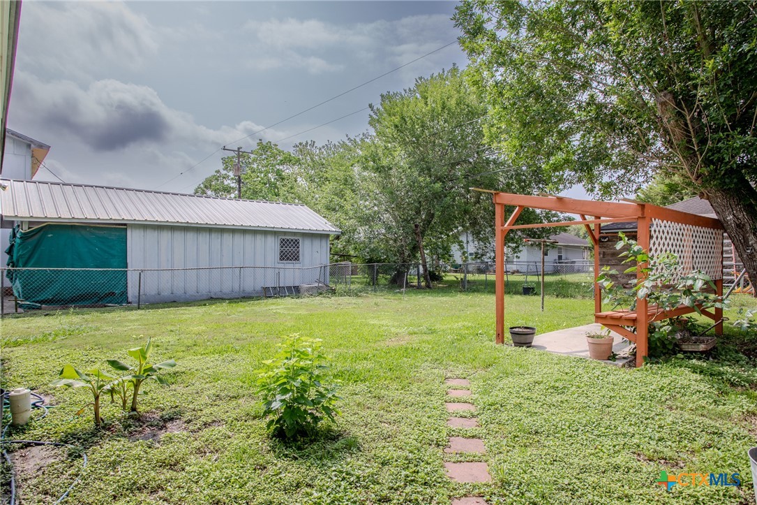 2903 Gayle Street Victoria, TX 77901 - Photo 20 of 21 a backyard of a house with childrens swings and slides