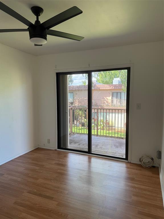 42 Matador Lane, Unit 524 Fort Lauderdale, FL 33324 - Photo 6 of 10 a view of an empty room with wooden floor and a window