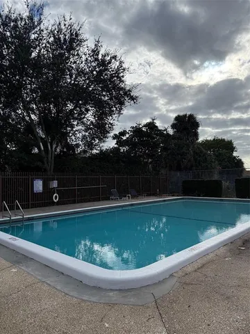 a view of a swimming pool with a yard