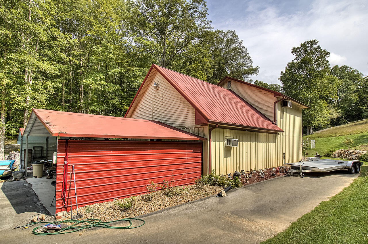 184 Davidson Hollow Road Heiskell, TN 37754 - Photo 1 of 40 a view of a white house with a small yard and large tree